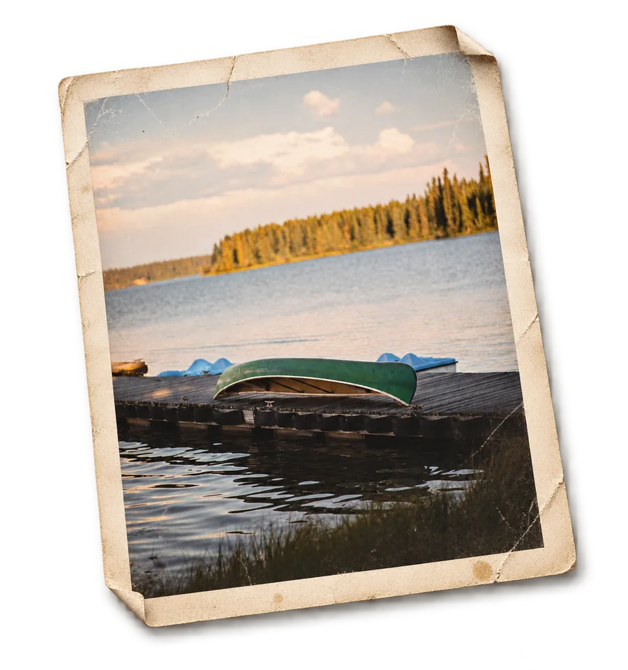 A canoe pulled up on the dock at Eagle&rsquo;s
               Nest Resort, as a weathered print.